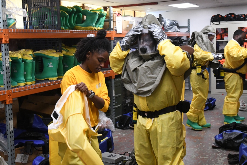 Sailors suit up in full personal protective equipment