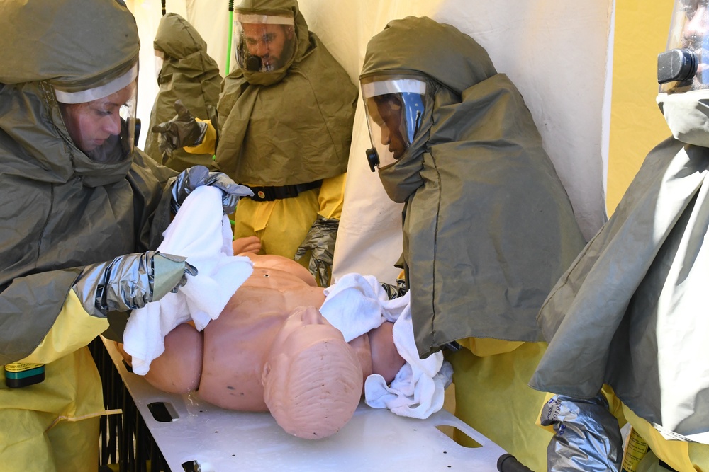 Sailors dry off simulated contaminated patient