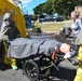 Sailors remove a simulated de-contaminated patient from the tent after decontamination