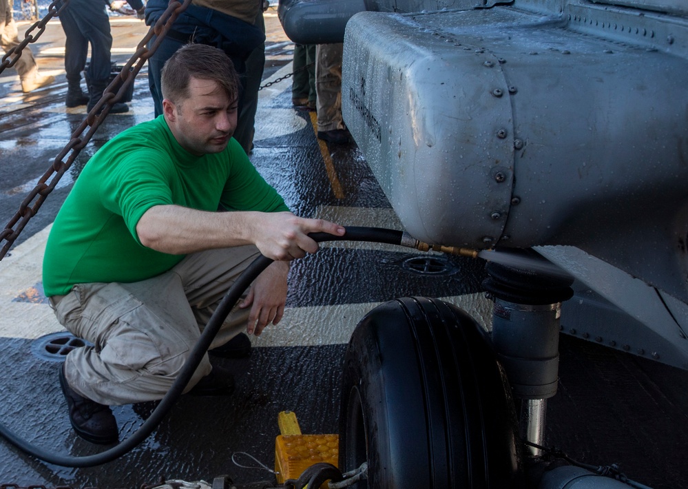 Sailors Aboard USS Ralph Johnson (DDG 114) Conduct a Helicopter Wash Down