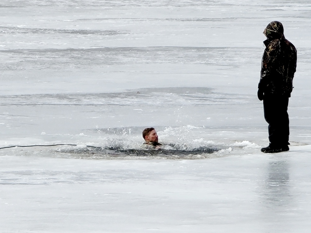 Cold-Weather Operations Course students jump in for cold-water immersion training at Fort McCoy