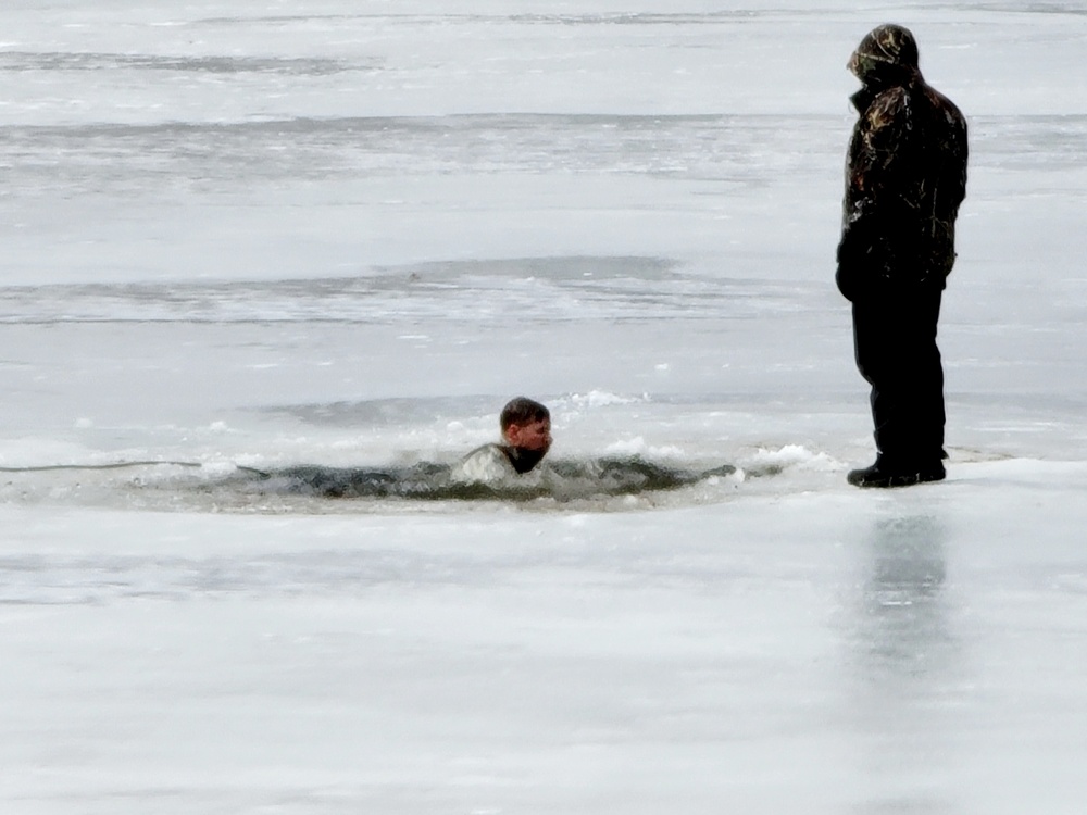 Cold-Weather Operations Course students jump in for cold-water immersion training at Fort McCoy