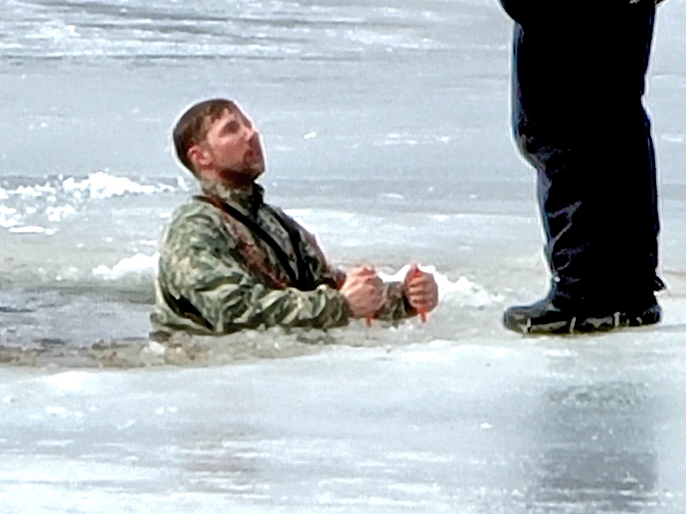 Cold-Weather Operations Course students jump in for cold-water immersion training at Fort McCoy