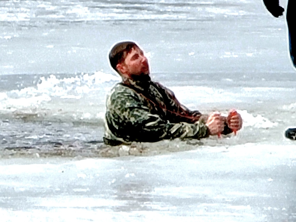 Cold-Weather Operations Course students jump in for cold-water immersion training at Fort McCoy