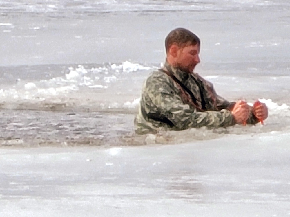 Cold-Weather Operations Course students jump in for cold-water immersion training at Fort McCoy