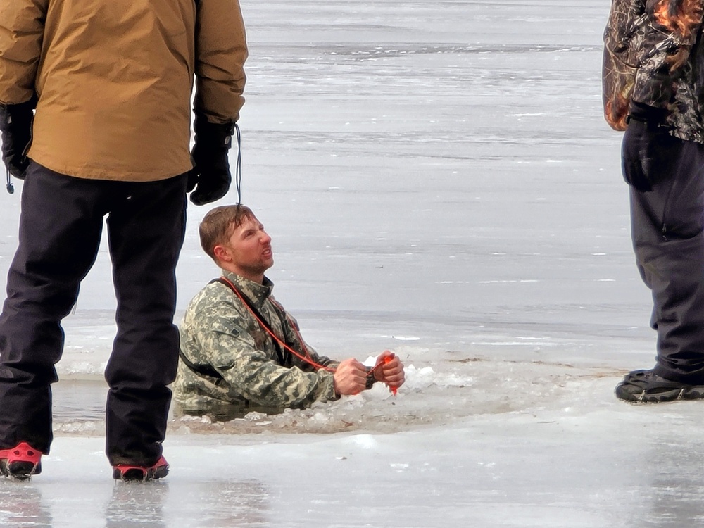 Cold-Weather Operations Course students jump in for cold-water immersion training at Fort McCoy