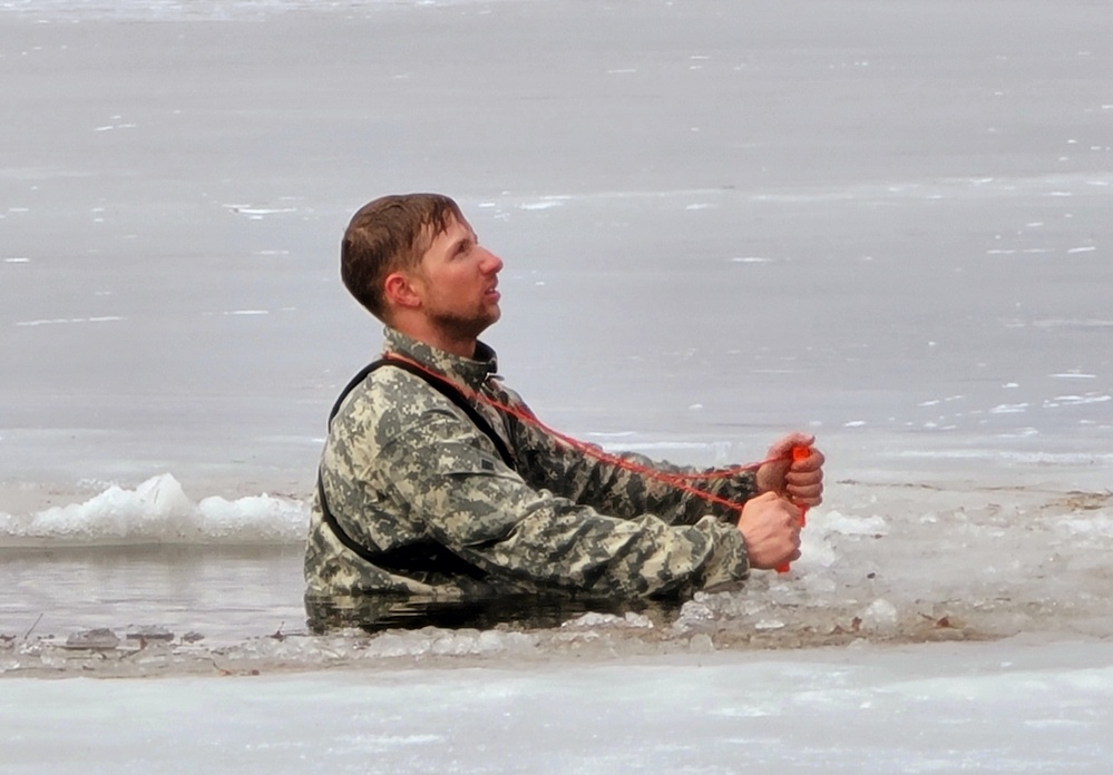 Cold-Weather Operations Course students jump in for cold-water immersion training at Fort McCoy