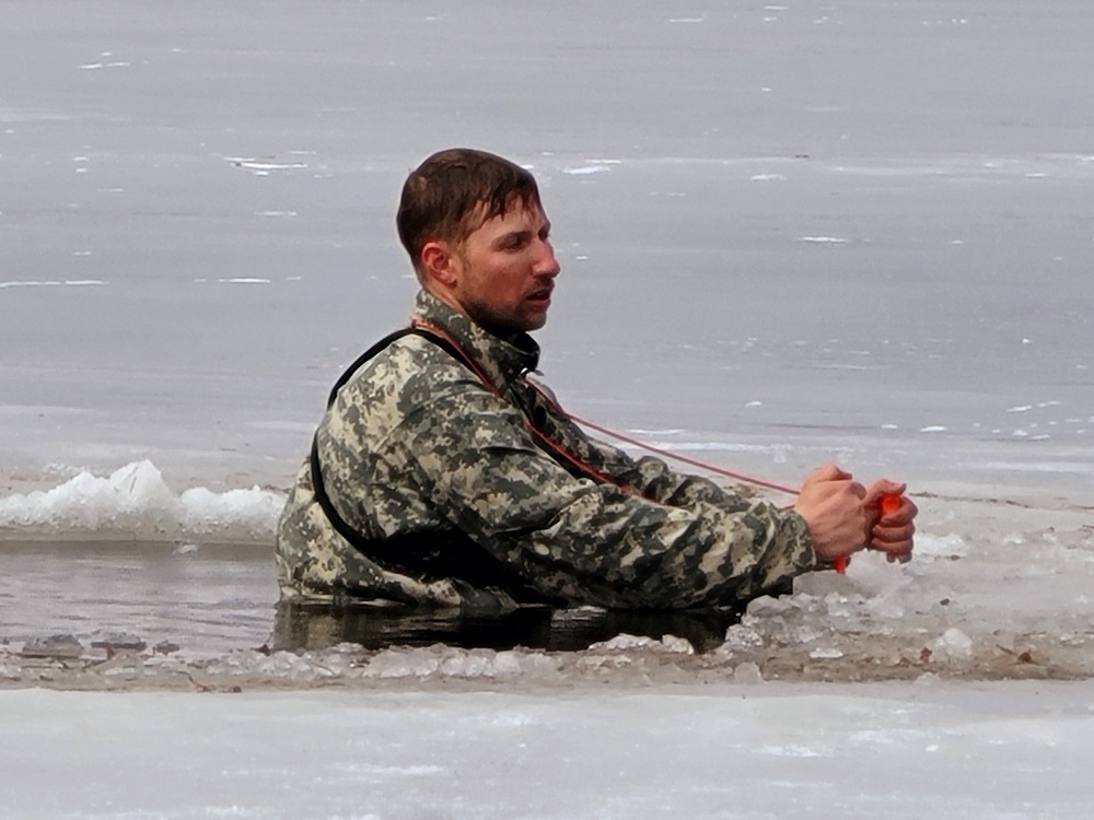 Cold-Weather Operations Course students jump in for cold-water immersion training at Fort McCoy