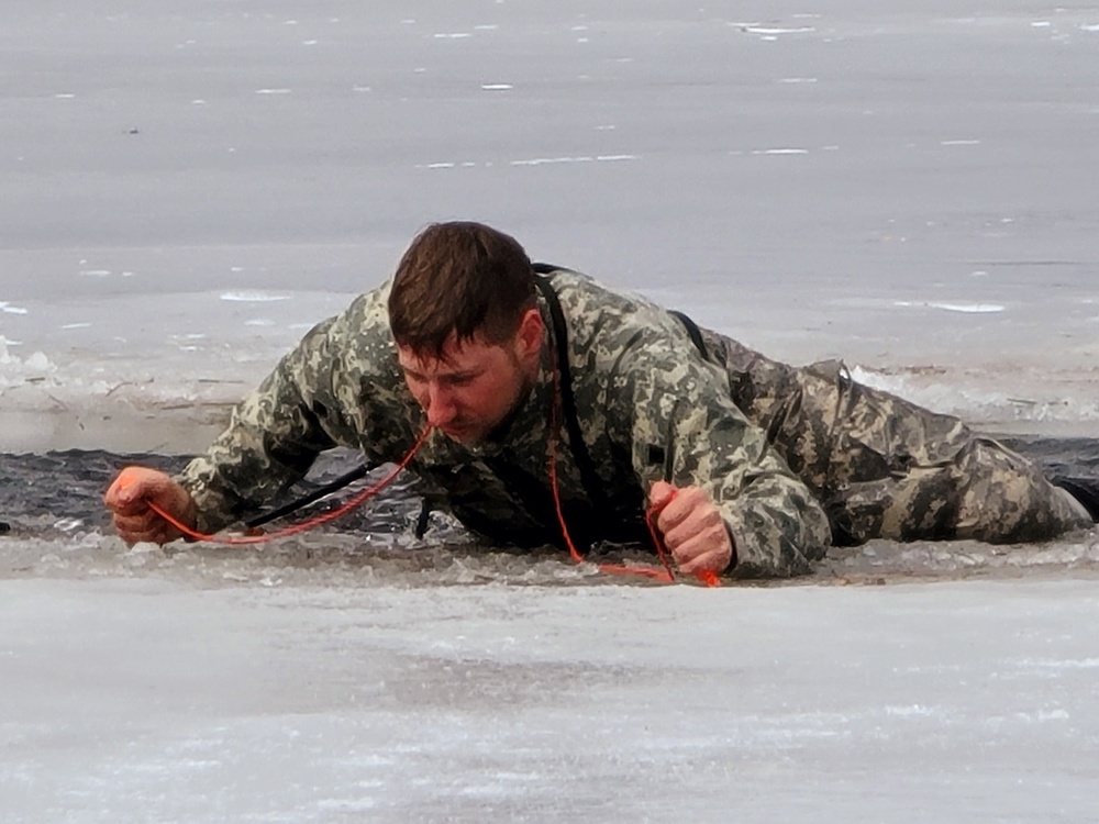 Cold-Weather Operations Course students jump in for cold-water immersion training at Fort McCoy