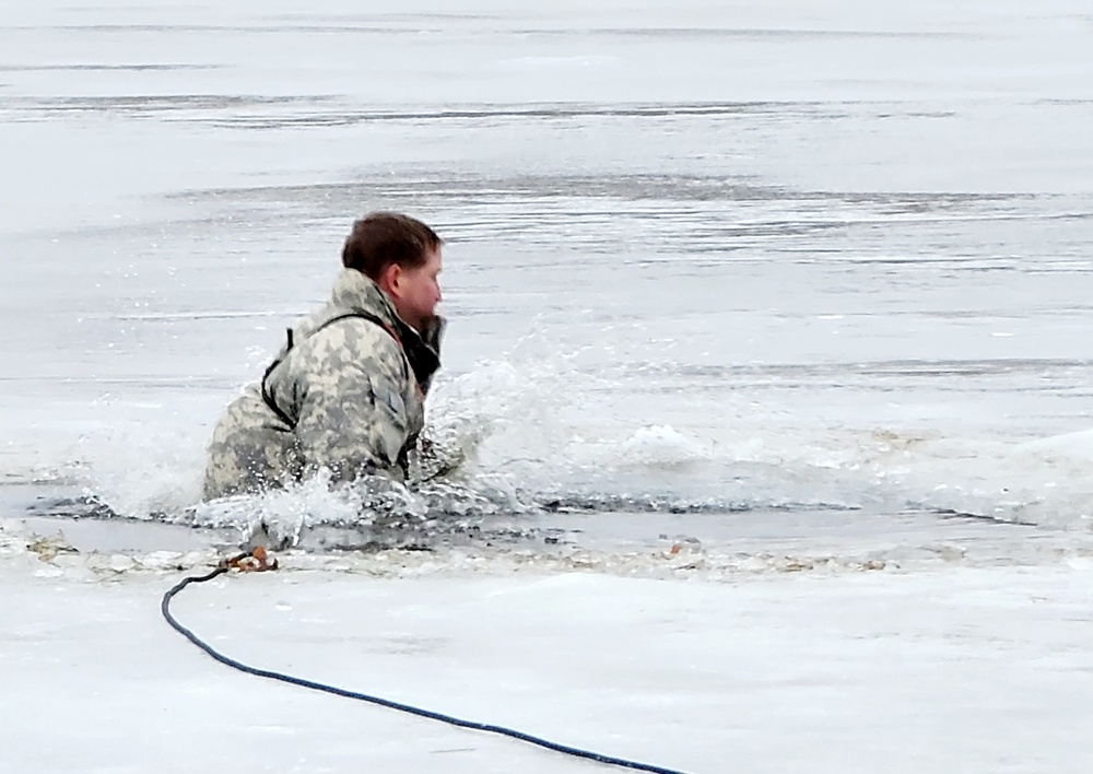 Cold-Weather Operations Course students jump in for cold-water immersion training at Fort McCoy