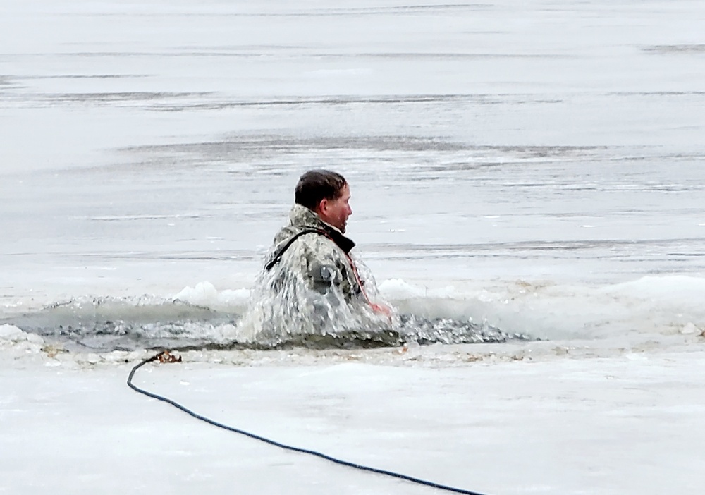 Cold-Weather Operations Course students jump in for cold-water immersion training at Fort McCoy