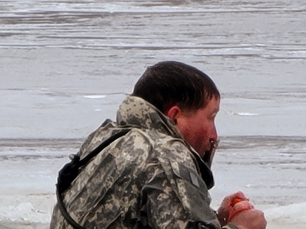 Cold-Weather Operations Course students jump in for cold-water immersion training at Fort McCoy