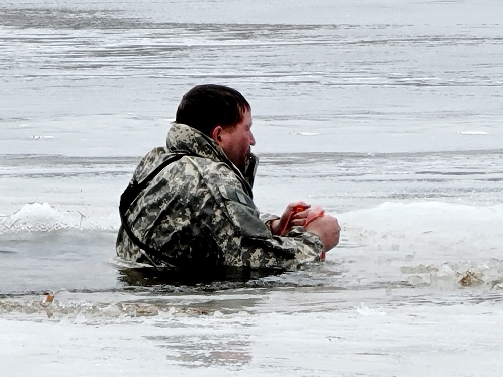 Cold-Weather Operations Course students jump in for cold-water immersion training at Fort McCoy