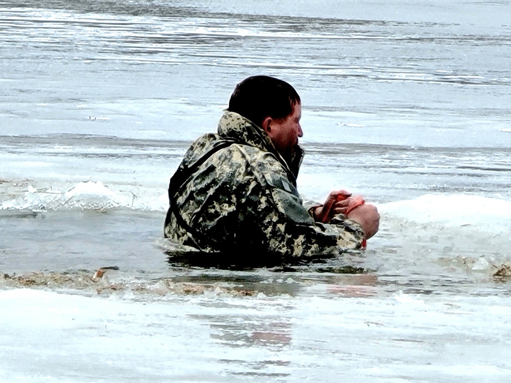 Cold-Weather Operations Course students jump in for cold-water immersion training at Fort McCoy