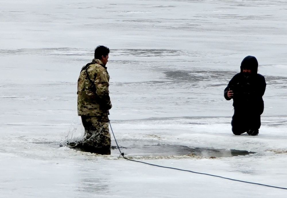 Cold-Weather Operations Course students jump in for cold-water immersion training at Fort McCoy