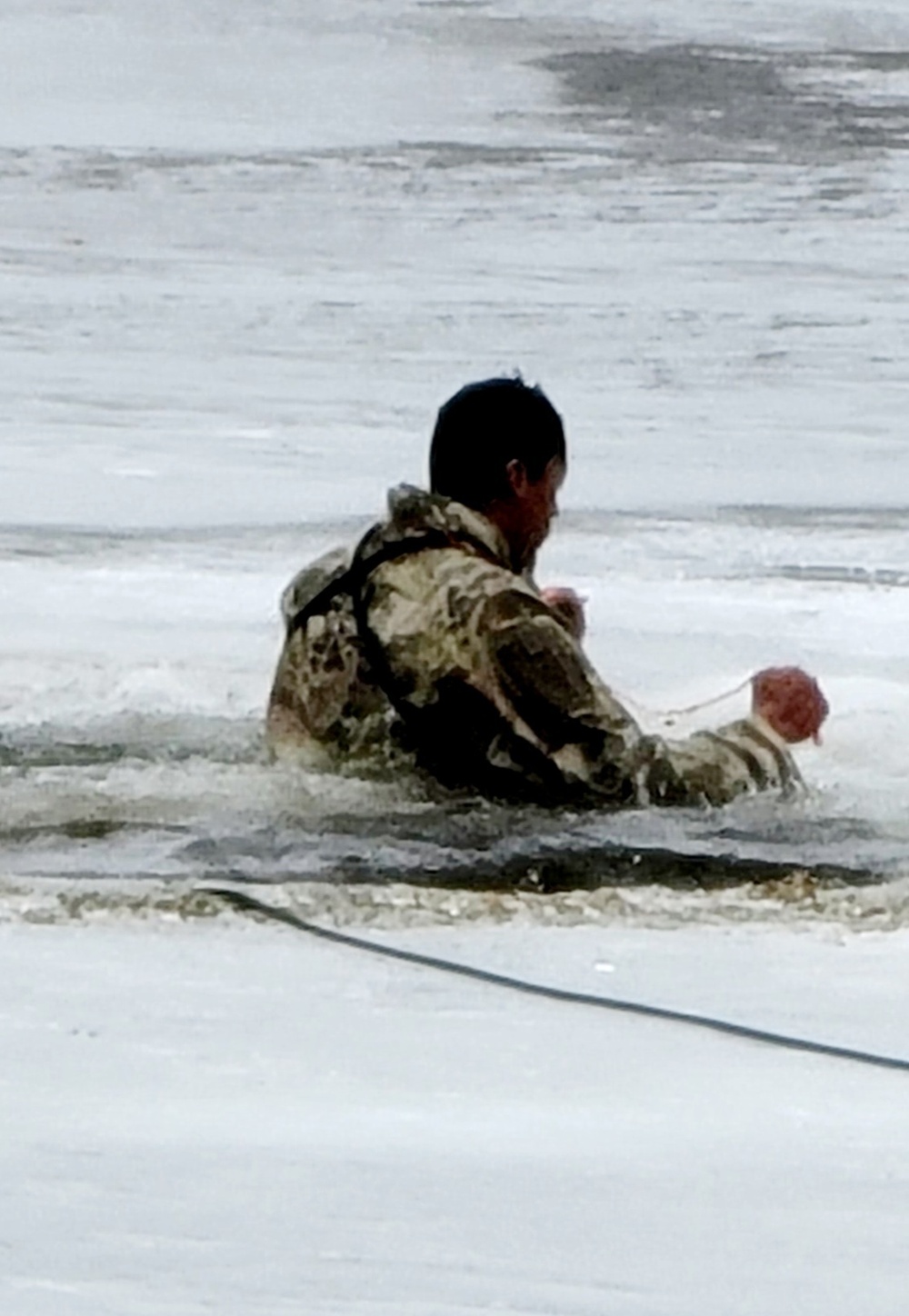 Cold-Weather Operations Course students jump in for cold-water immersion training at Fort McCoy