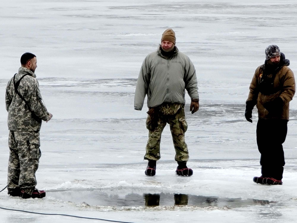 Cold-Weather Operations Course students jump in for cold-water immersion training at Fort McCoy