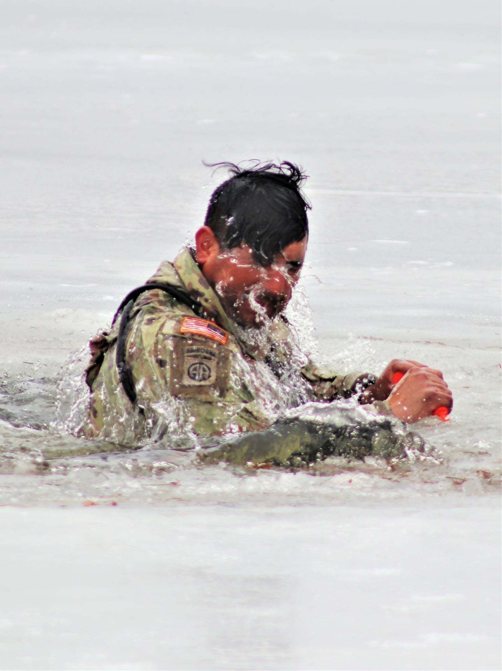 Cold-Weather Operations Course students jump in for cold-water immersion training at Fort McCoy