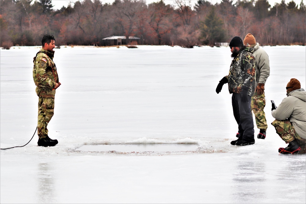 Cold-Weather Operations Course students jump in for cold-water immersion training at Fort McCoy