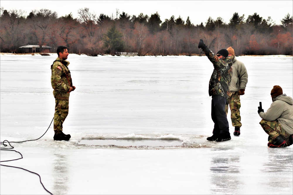 Cold-Weather Operations Course students jump in for cold-water immersion training at Fort McCoy