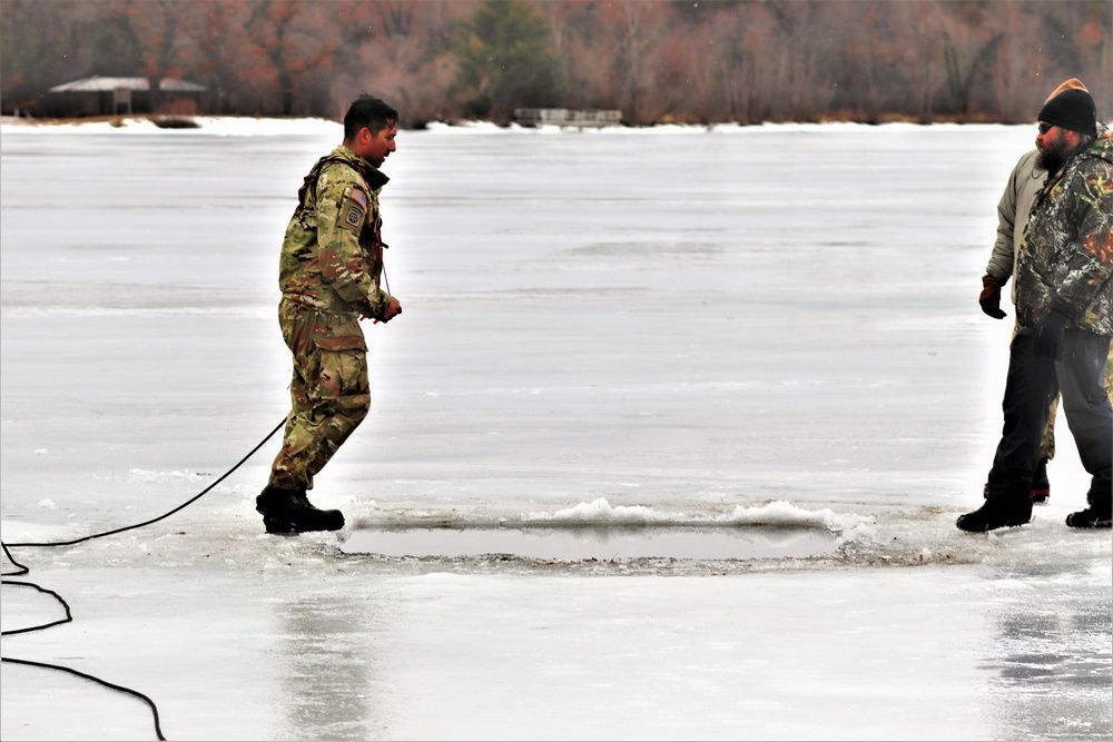 Cold-Weather Operations Course students jump in for cold-water immersion training at Fort McCoy