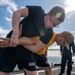 Fire Controlman (AEGIS) 3rd Class Stephen Williamson (left), from Columbia Falls, Mont., practices takedown techniques with Fire Controlman (AEGIS) 3rd Class Liangchao Ou (right), from San Diego, Calif.