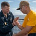 Master-at-Arms 1st Class Trenton McKibben (left), from Orlando, Fla., teaches takedown techniques with Fire Controlman (AEGIS) 3rd Class Liangchao Ou (right), from San Diego, Calif., during Security Reaction Force – Basic training course