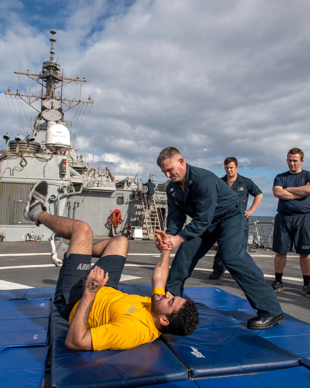 Master-at-Arms 1st Class Trenton McKibben (top), from Orlando, Fla., demonstrates takedown techniques with Sonar Technician (Surface) Seaman Jerome Bryant (bottom), from Milwaukee, Wis., during Security Reaction Force – Basic training course