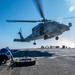 Boatswain’s Mate 3rd Class Brian Bisarz, from Long Island, N.Y., prepares to chock and chain a MH-60R Sea Hawk helicopter