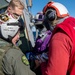 Logistics Specialist 2nd Class Nicholas Forbes (right), from Norfolk, Va., exchanges command patches with an aircrewman