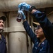 Gas Turbine Systems Technician (Mechanical) Dylan Mai (right), from Los Angeles, Calif., verifies an oil sample is clear and bright with Gas Turbine Systems Technician (Electrical) 3rd Class Zachary Wiley (left), from Lufkin, Texas