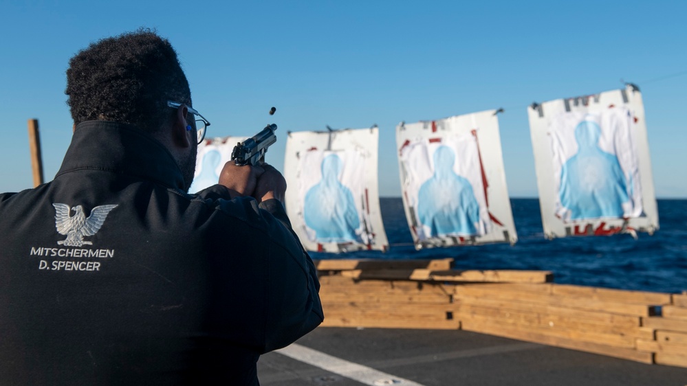 Gas Turbine Systems Technician 3rd Class Demario Spencer, from Monroe, La., fires a M9 Berretta service pistol during a small-arms live-fire exercise