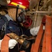 Gas Turbine Systems Technician (Electrical) 3rd Class Zachary Wiley, from Lufkin, Texas, prepares a hose during a firefighting drill