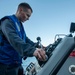 Machinist Mate 1st Class Kenneth Peterson, from Houston, Texas, conducts a maintenance on a ridged-hull inflatable boat