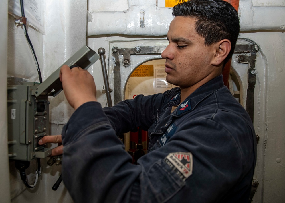 Gunner’s Mate 2nd Class Roberto Ponce, from Albuquerque, N.M., conducts maintenance on a magazine sprinkler system