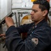 Gunner’s Mate 2nd Class Roberto Ponce, from Albuquerque, N.M., conducts maintenance on a magazine sprinkler system