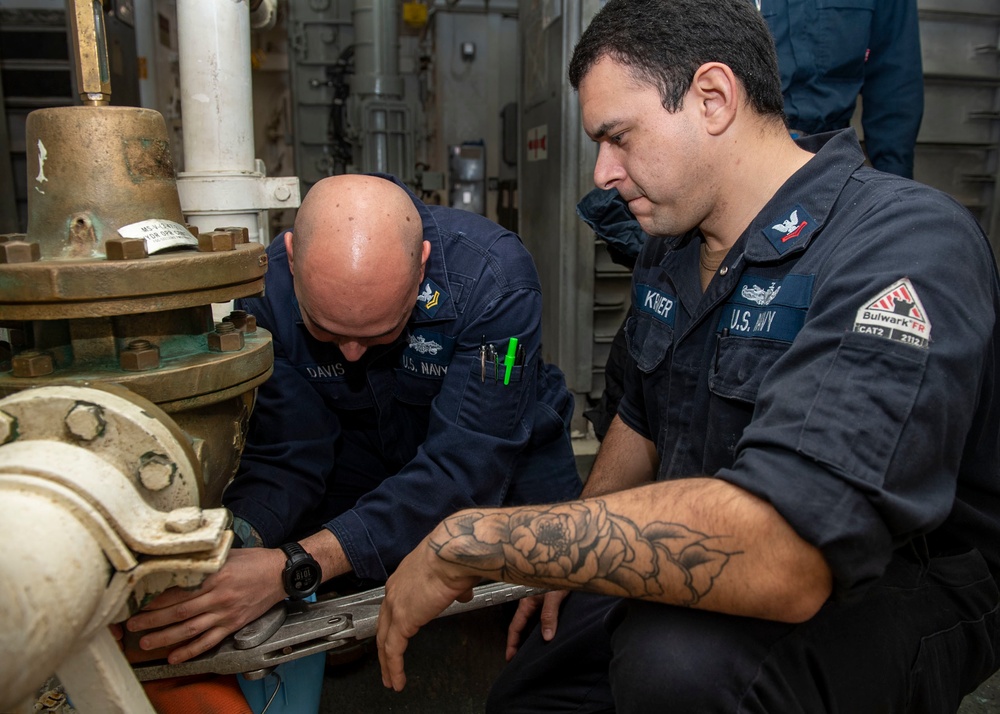 Gunner’s Mate 2nd Class Jay Davis (left), from Virginia Beach, Va., and Fire Controlman 2nd Class Ryan Kreiner (right), from Temecula, Calif., conduct maintenance on a magazine sprinkler system