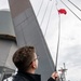 Quartermaster 1st Class John Wagner, from Denver, Colo., hoists the bravo flag during a replenishment-at-sea