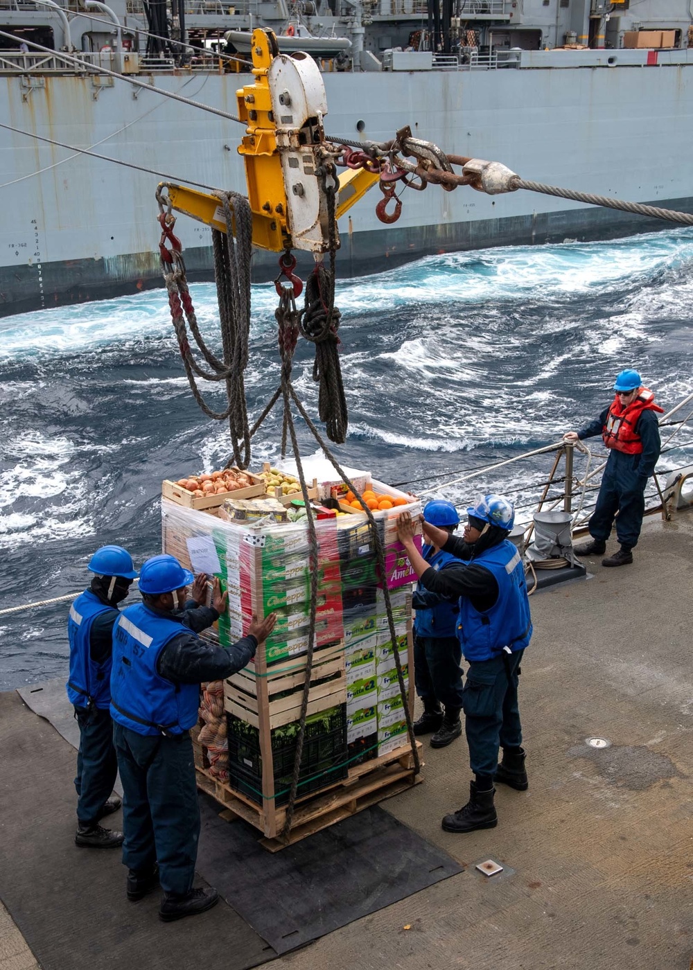 Sailors aboard Arleigh Burke-class guided-missile destroyer USS Mitscher (DDG 57) receive stores