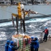 Sailors aboard Arleigh Burke-class guided-missile destroyer USS Mitscher (DDG 57) receive stores