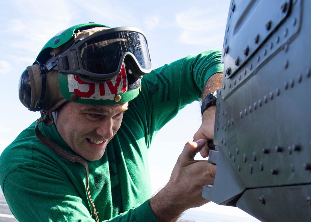 Sailor Conducts Maintenance On An MH-60S Sea Hawk Helicopter