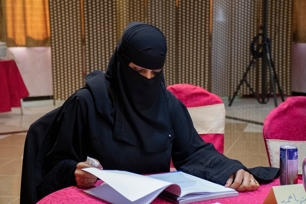 A community reproductive health volunteer trained with USAID funding reviews the volunteer reference materials for reproductive, newborn and child health in Aden, Yemen in December 2021. T