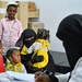 A healthcare worker trained with USAID funding provides child health care services to a family at Al-Anad Health Center in Tuban district in Lahj Governorate in December 2021.