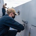 USS Portland (LPD 27) Sailors perform ship preservation