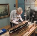 Volunteer model ship builder at Naval Museum