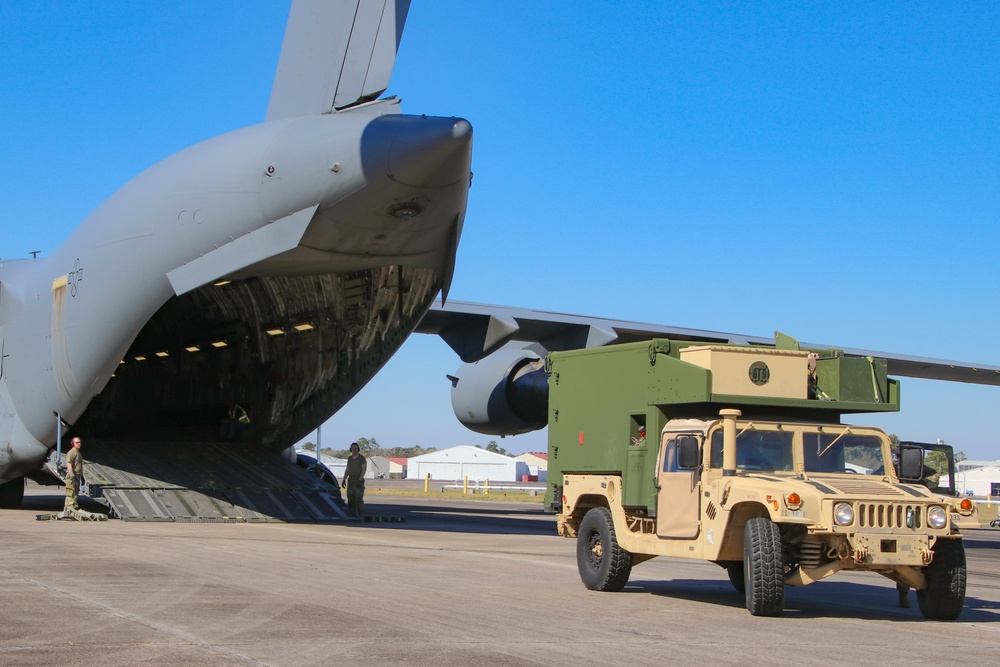 Service members load equipment for a deployment Europe