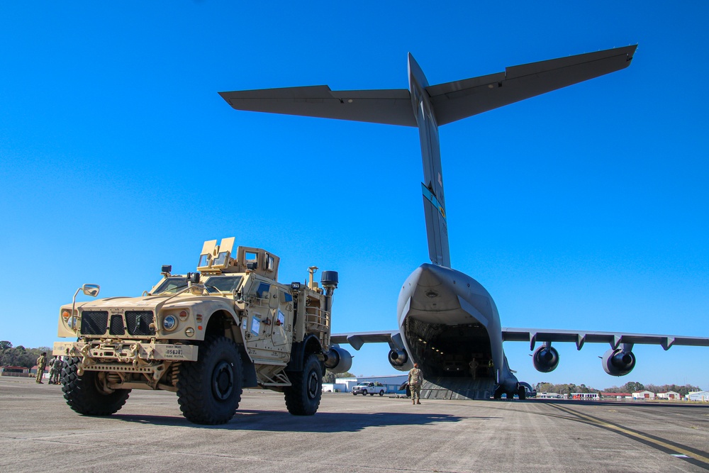 Service members load equipment for a deployment Europe