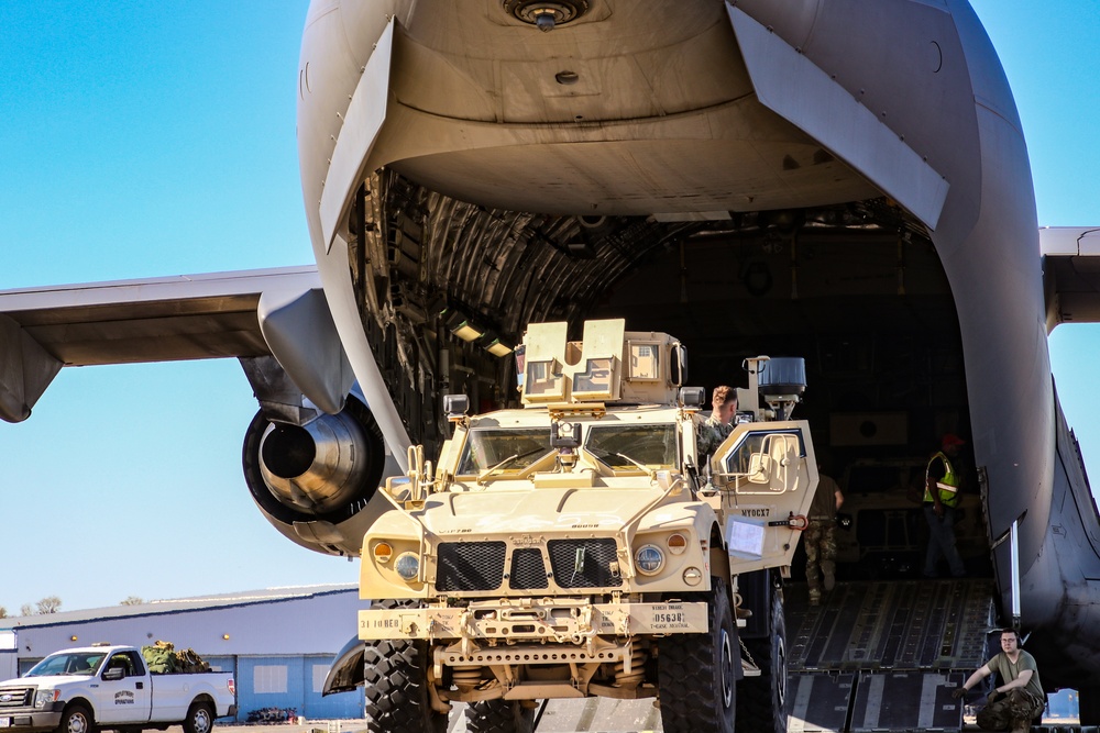 Service members load equipment for a deployment Europe