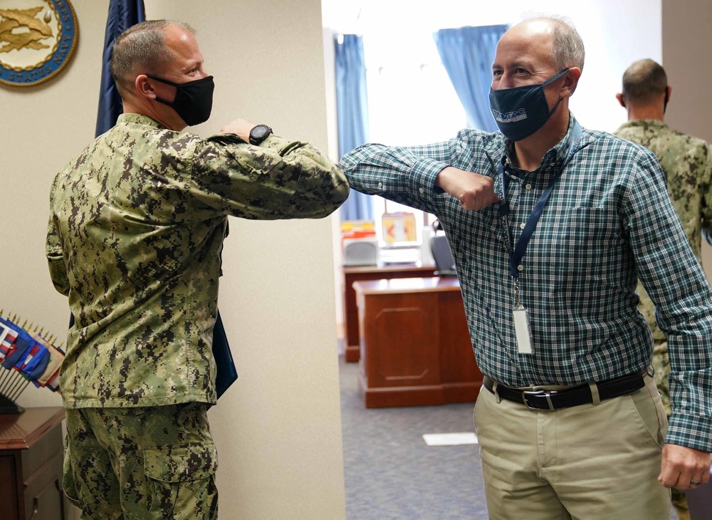CDR Courtney Stringham and Kenneth Booth bump elbows at NAVFAC Washington HQ