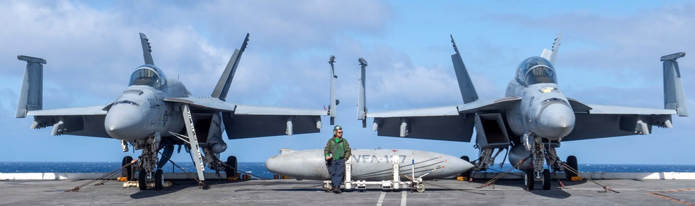 wAn F/A-18F Super Hornet And An F/A-18E Super Hornet Rest On The Flight Deck